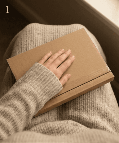 A closed, unbranded brown mailer resting on a lap