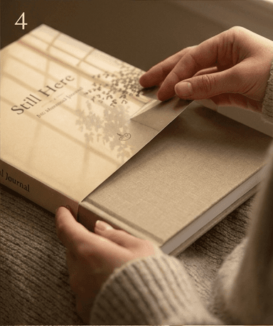 The matte dust jacket being lifted away from the journal