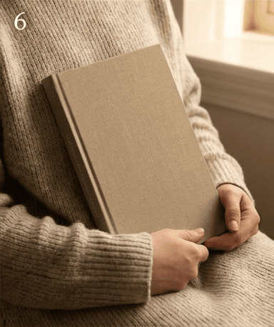 Two hands holding the finished linen hardcover journal
